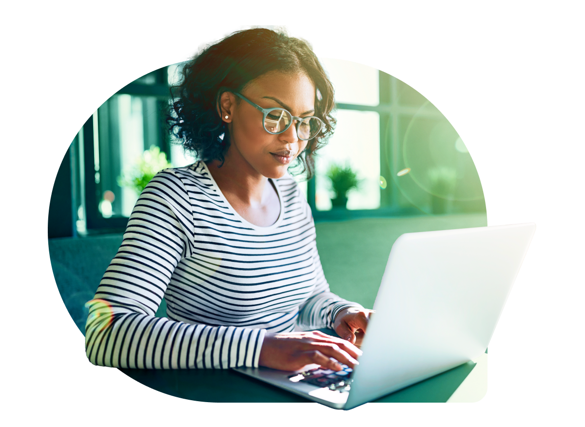 a woman sitting at a table using a laptop