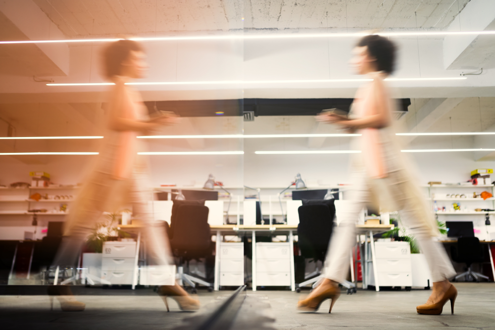 two people walking in an office