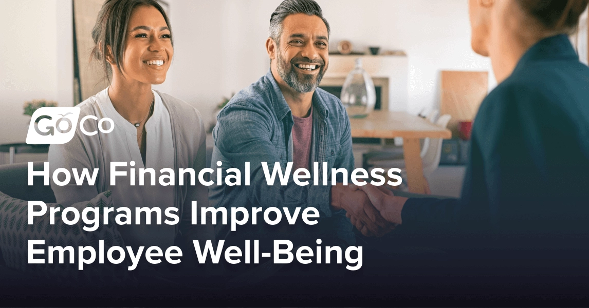 A smiling couple speaking to and shaking hands with a financial advisor.